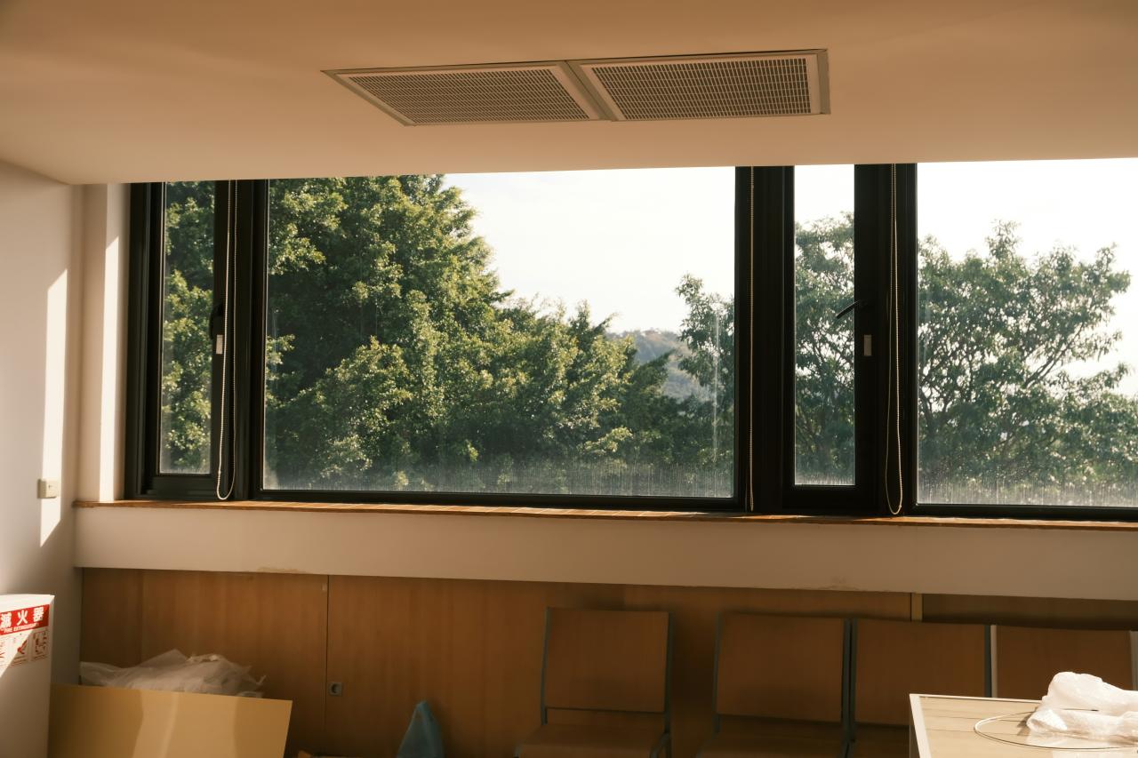 A room with a lot of windows and boxes on the floor