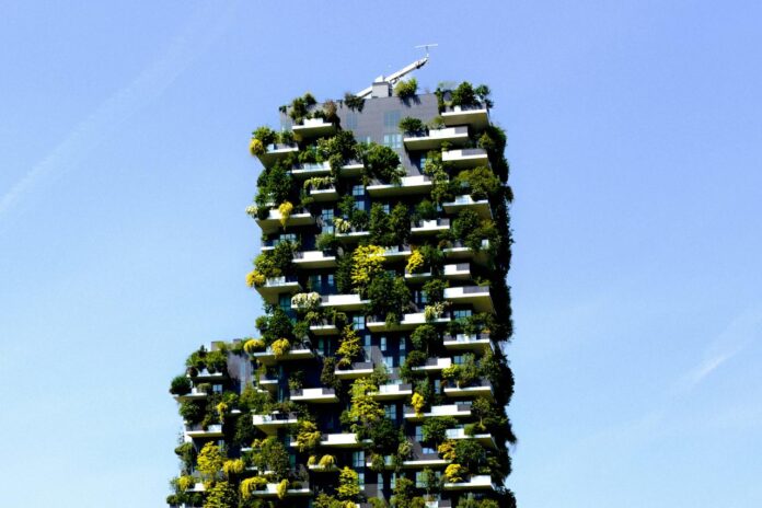 a very tall building with plants growing on it